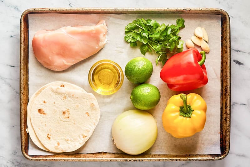 Grilled chicken fajitas ingredients on a tray.