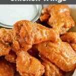 Copycat Hooters wings and a small bowl of dipping sauce.
