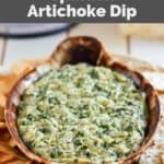 Homemade Houston's spinach artichoke dip, pita chips, and cracker on a platter.