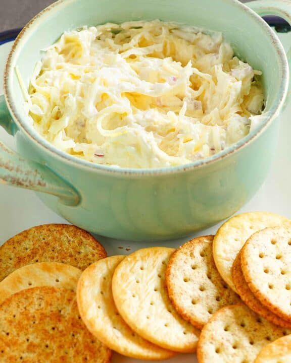 Copycat Kroger Jarlsberg cheese dip in a bowl and butter crackers next to it.