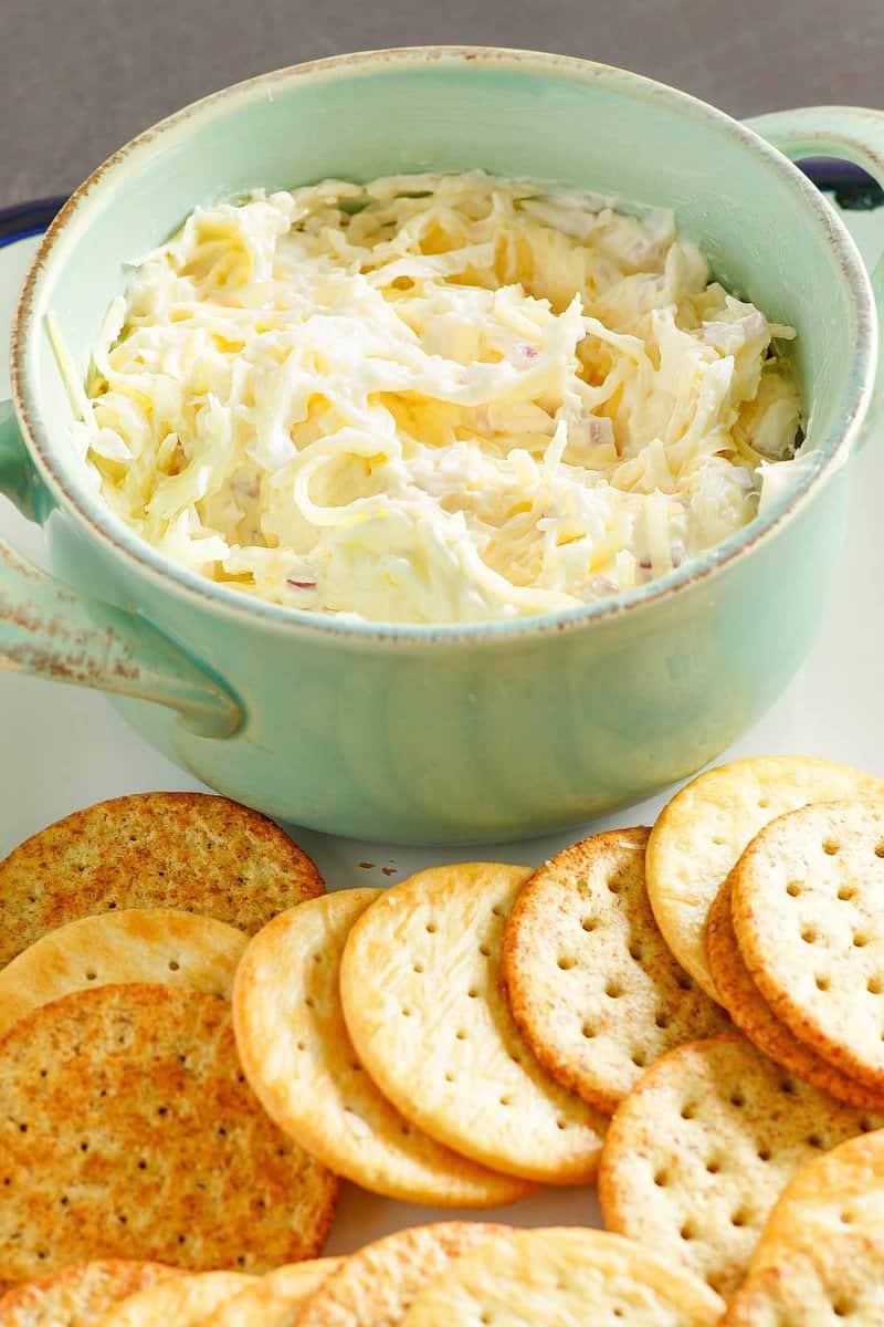 Copycat Kroger Jarlsberg cheese dip in a bowl and butter crackers next to it.
