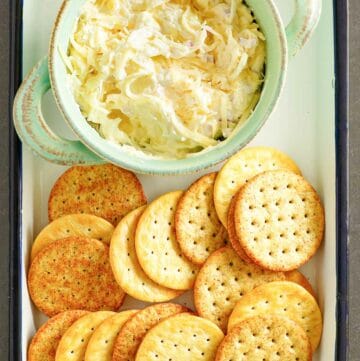 Copycat Kroger Jarlsberg cheese dip and crackers on a serving tray.