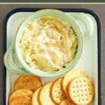 A bowl of homemade Kroger Jarlsberg cheese dip and butter crackers on a tray.