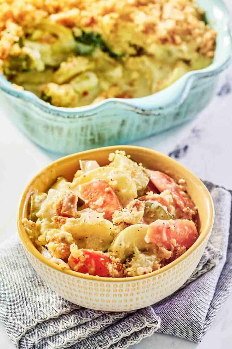 A bowl of copycat Luby's squash casserole and the casserole behind it.