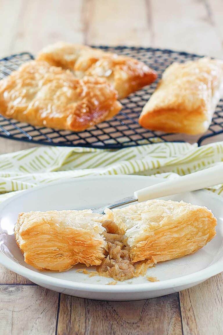 Copycat McDonald's apple pie on a plate and three on a wire rack.