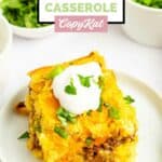A serving of Mexican cornbread casserole garnished with sour cream and cilantro.