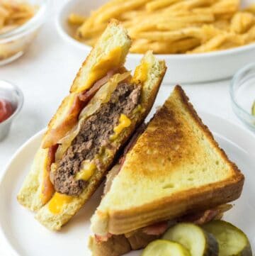 Copycat Waffle House Texas bacon patty melt on a plate and a bowl of fries.