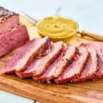 Baked corned beef on a wood board.