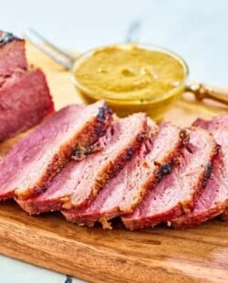 Baked corned beef on a wood board.