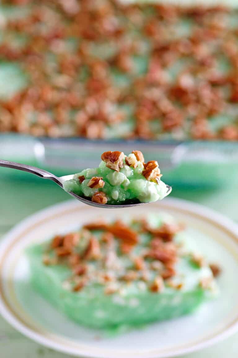 Copycat Furr's cafeteria lime jello salad on a spoon and plate and in a baking dish.