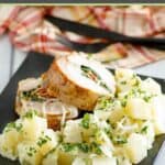 Parsley potatoes with onions and slices of stuffed pork loin on a plate.