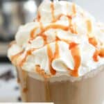 Homemade Starbucks caramel latte with whipped cream and caramel drizzle.