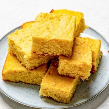 Copycat Tippin's cornbread slices stacked on a plate.