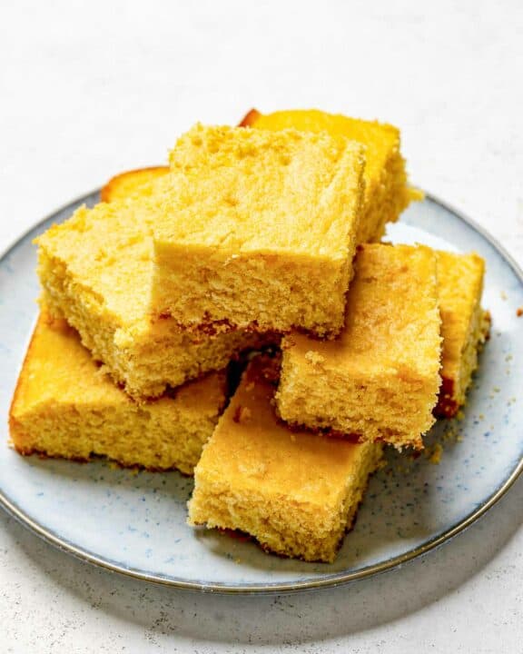 Copycat Tippin's cornbread slices stacked on a plate.