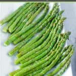 Air fried asparagus spears on a large platter.
