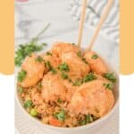 Air fryer bang bang shrimp and rice in a bowl.