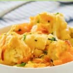Baked cauliflower with cheese sauce in a dish.