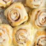 Copycat cinnamon rolls with frosting in a baking pan.