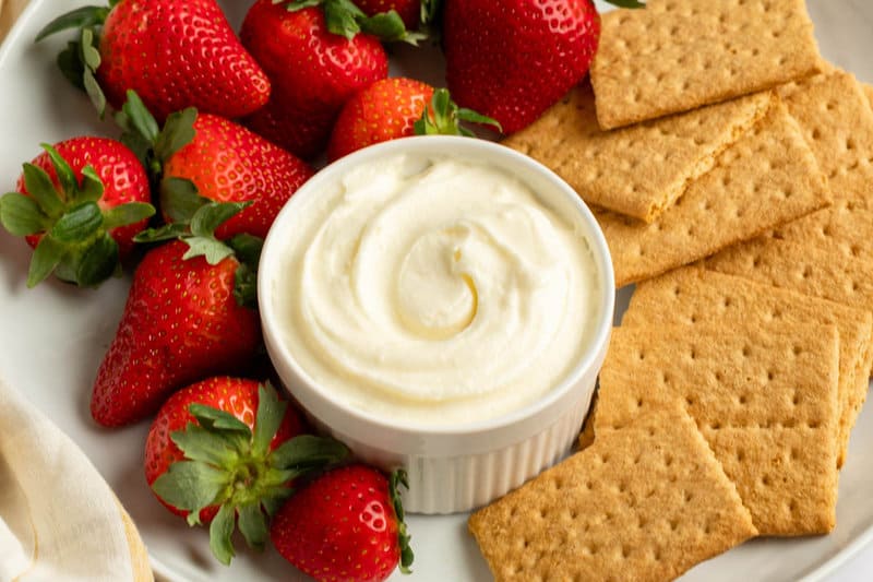 Cinnabon cream cheese frosting dip, strawberries, and graham crackers.