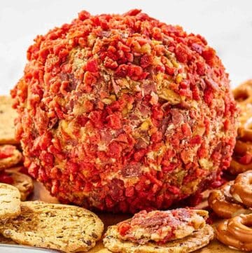 French onion cheese ball and crackers on a platter.