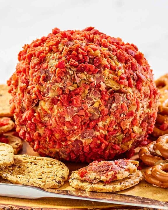 French onion cheese ball and crackers on a platter.