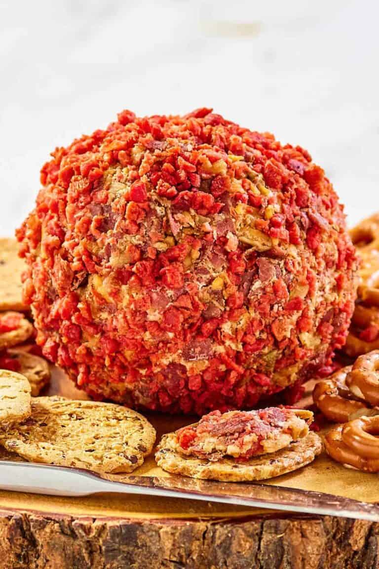 French onion cheese ball and crackers on a platter.