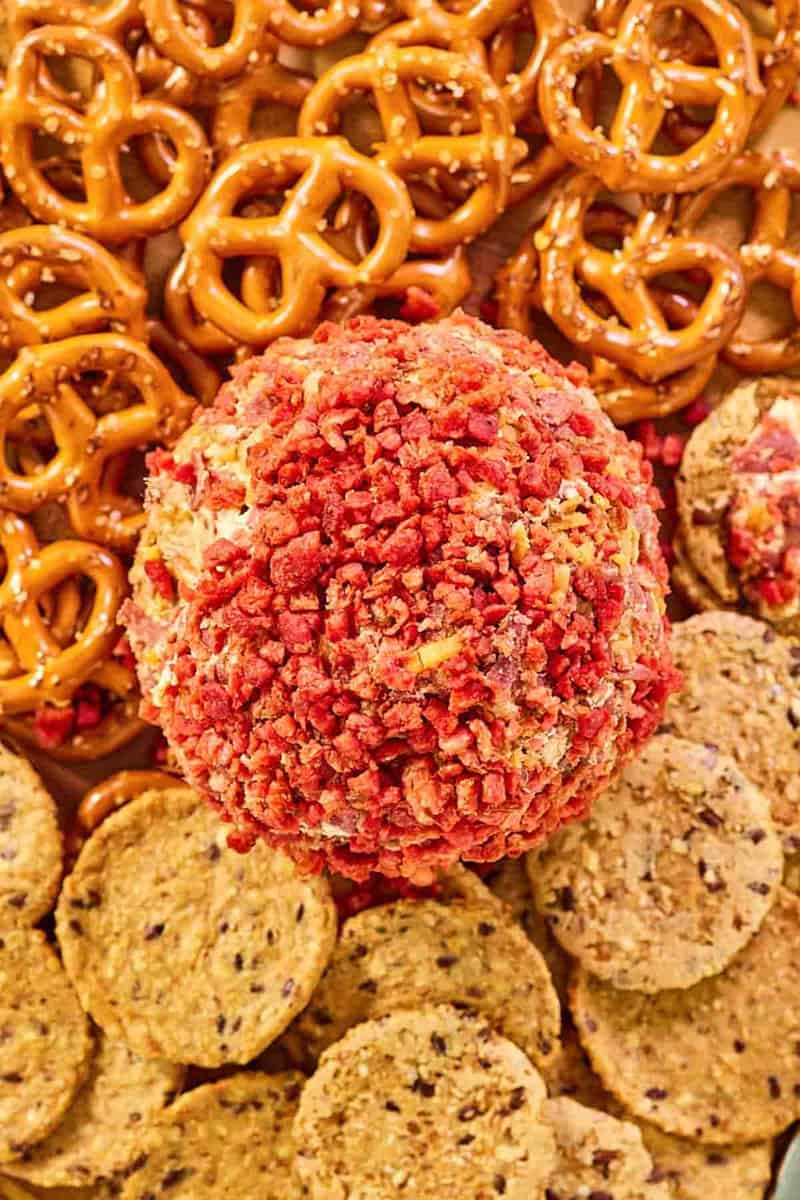 French onion cheese ball with pretzels and crackers next to it.