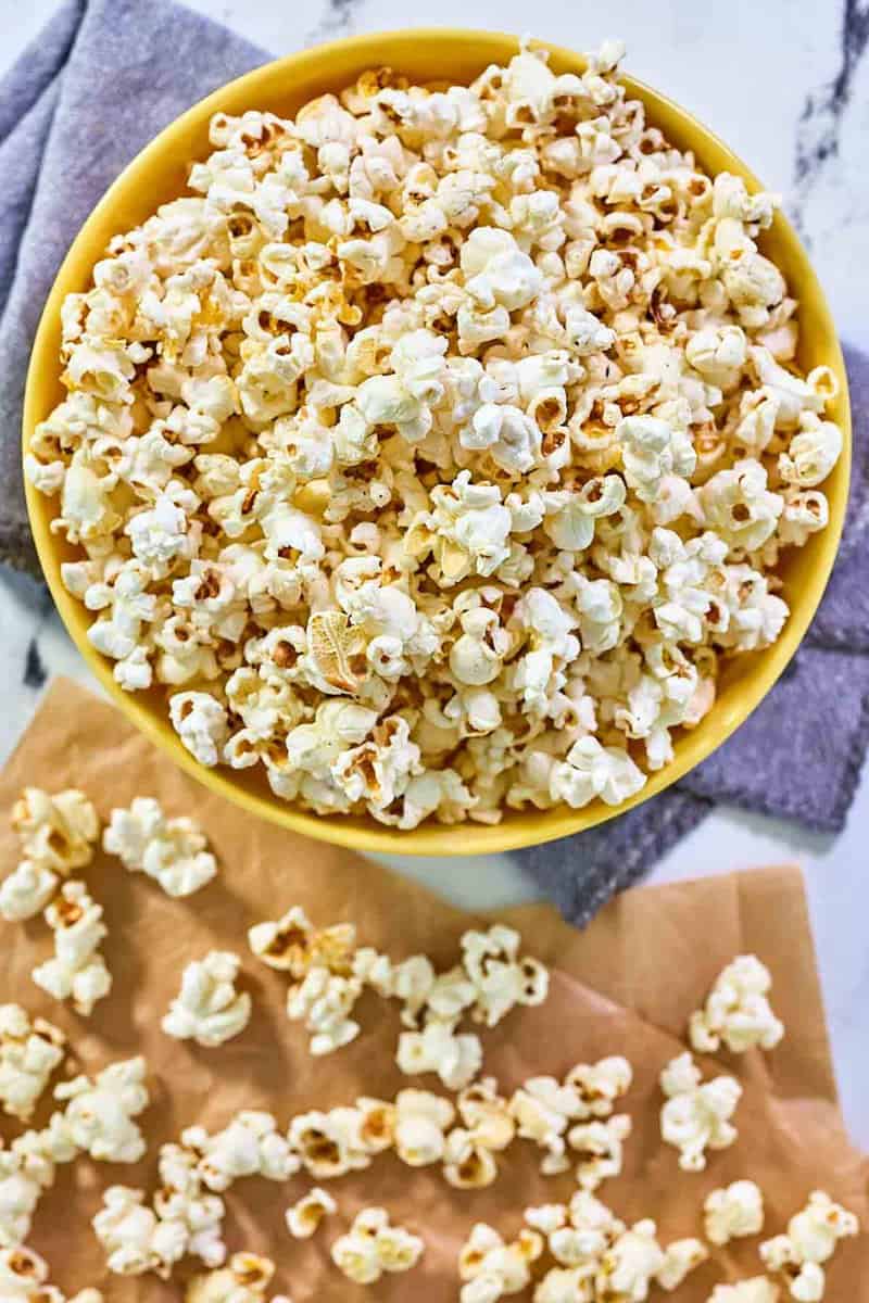 Instant pot popcorn in a bowl and scattered beside it.