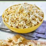 Instant pot popcorn in a large bowl and scattered in front of it.