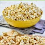 Instant pot popcorn in a large bowl and scattered on parchment paper.