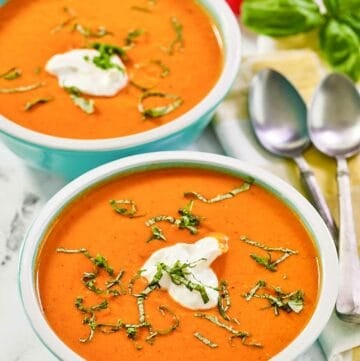 Copycat La Madeleine red pepper soup in two bowls.