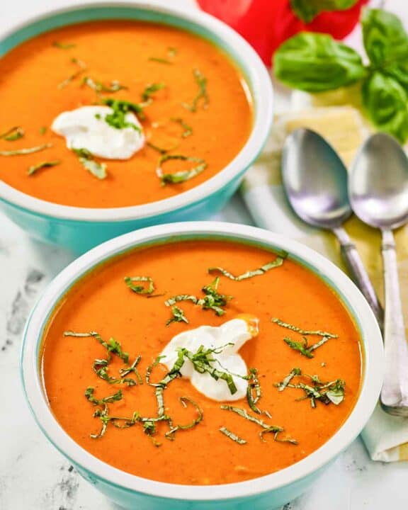Copycat La Madeleine red pepper soup in two bowls.