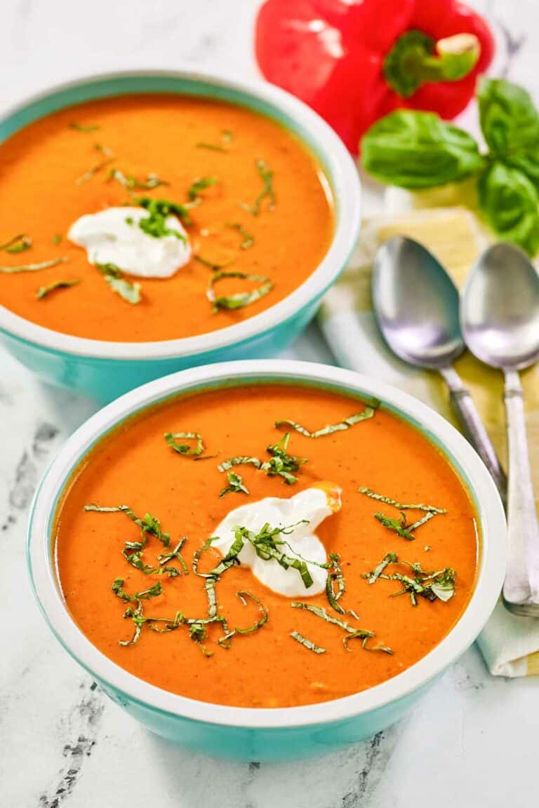 Copycat La Madeleine red pepper soup in two bowls.