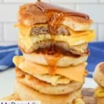 Pouring syrup over a stack of homemade McGriddle breakfast sandwiches.