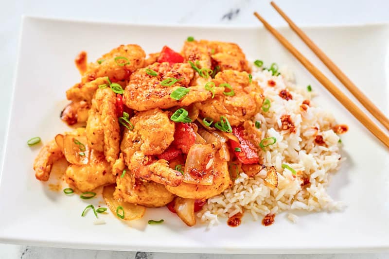 Copycat Panda Express chili crisp shrimp and steamed rice on a plate.