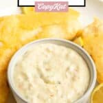 A bowl of homemade Red Lobster tartar sauce and fried fish sticks on a plate.