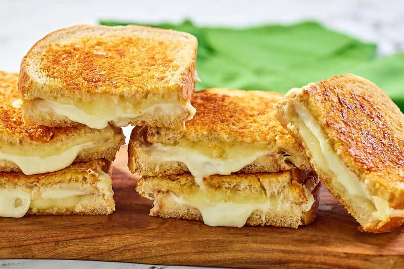 Copycat Starbucks grilled cheese sandwich halves on a wood board.