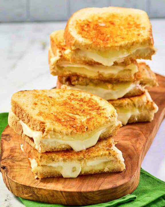 Copycat Starbucks grilled cheese sandwiches on a wood board.