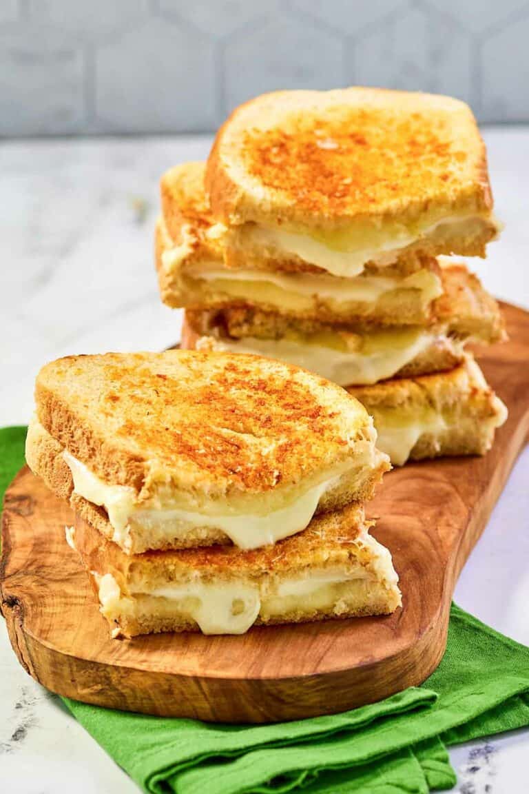 Copycat Starbucks grilled cheese sandwiches on a wood board.