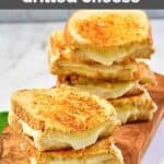 Homemade Starbucks grilled cheese sandwiches on a wood serving board.