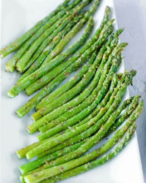 Air fryer asparagus spears on a platter.