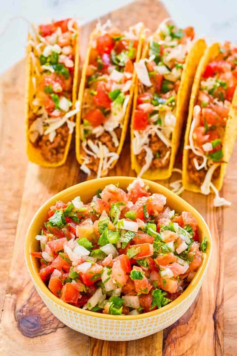 A bowl of copycat Applebee's pico de gallo and four tacos.
