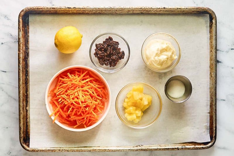 Copycat Chick Fil A carrot raisin salad ingredients on a tray.