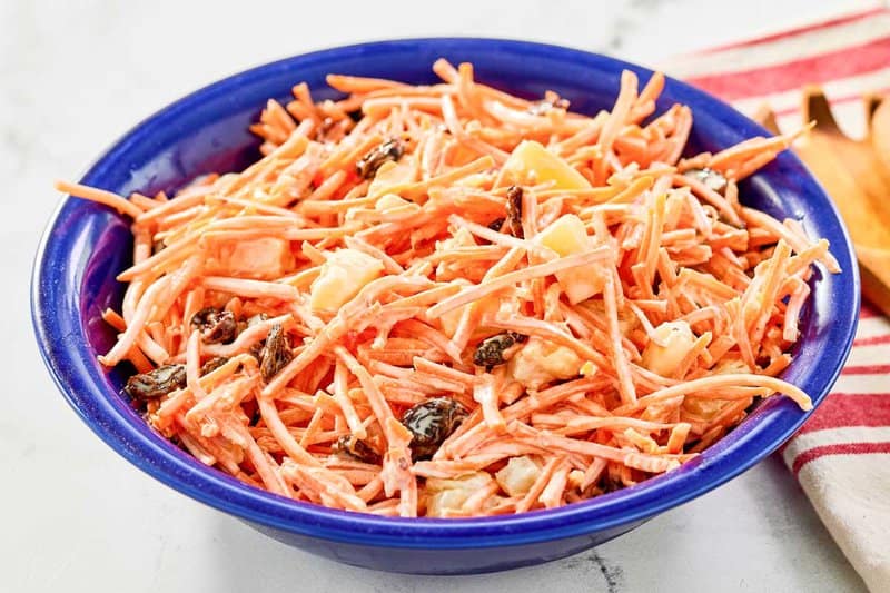 A bowl of copycat Chick Fil A carrot raisin salad.