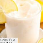 Homemade chick fil a frosted lemonade garnished with a lemon wheel.