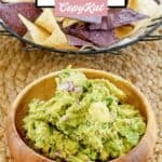 Homemade Chipotle guacamole in a bowl and tortilla chips in a basket.