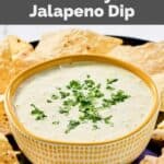 Homemade Chuy's creamy jalapeno dip in a bowl on a platter with tortilla chips.