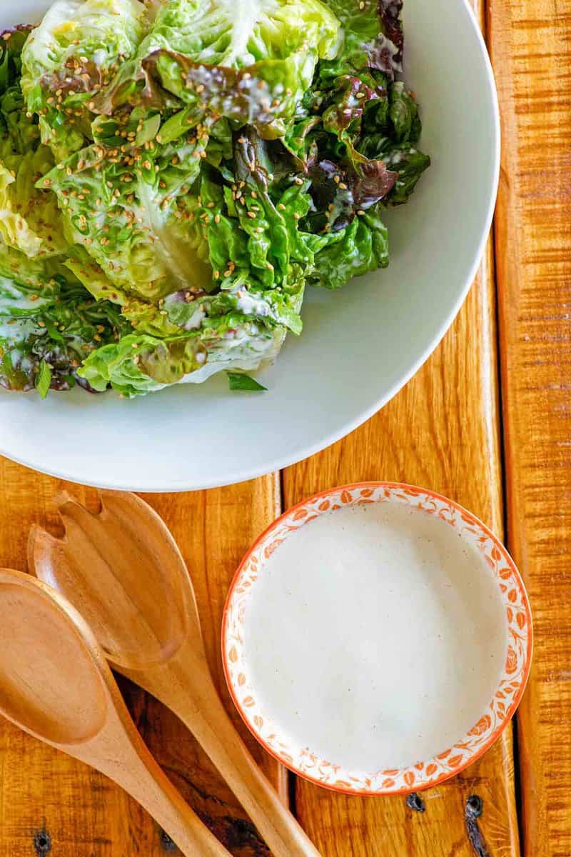 Homemade creamy Japanese salad dressing in a bowl and a salad.