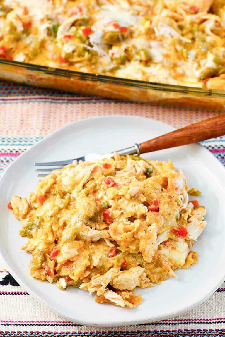 King ranch casserole in a baking dish and a serving on a plate.