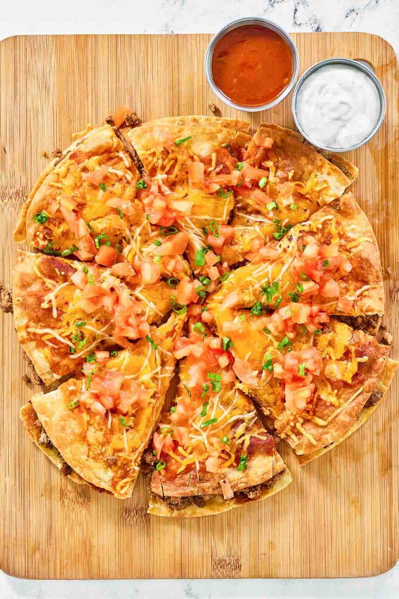 Copycat Taco Bell Mexican pizza, taco sauce, and sour cream.